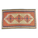 Carpet / Rug: A Senneh Kilim the cream and terracotta ground decorated with geometric and folaite