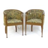 A pair of early 20thC tub chairs with bowed backrests, turned front legs and inlaid seat rails. 21