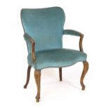 An 18thC French Hepplewhite library chair / open armchair with a shaped, upholstered backrest and
