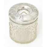 A cut glass dressing table jar / hair tidy with a silver lid, hallmarked Chester c.1905, maker J & R
