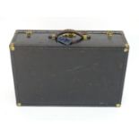 An early 20thC Oshkosh steamer trunk. the leather and wood case having studwork detailing and