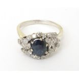 A Continental 18k gold ring set with central blue stone bordered by diamonds. Ring size P Please