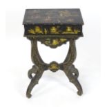 A 19thC oriental style work table, having an ebonised finish and painted chinoiserie decoration,