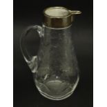 A glass jug / pitcher with floral decoration and silver rim hallmarked London 1892 retailer