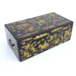 A 19thC lacquered writing box with chinoiserie decoration depicting pagoda style buildings,