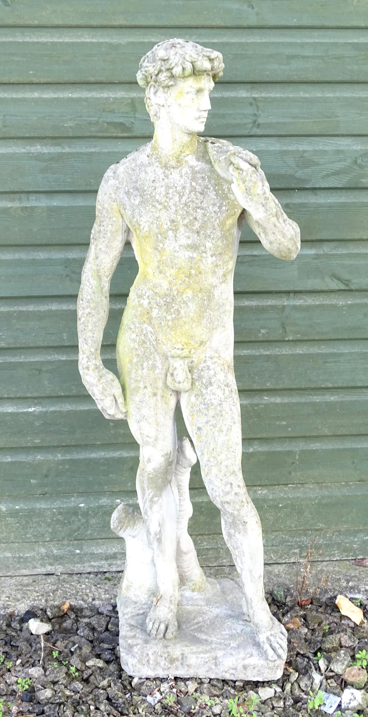 A 20thC composite stone garden statue of a Classical male figure, after Michelangelo's David.