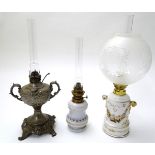 Three early 20thC oil lamps, comprising The New Rochester Jr., and two French porcelain examples,