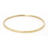 A 9ct gold bangle bracelet Please Note - we do not make reference to the condition of lots within