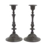 A pair of 19thC German cast candlesticks with scrolling detail. Marked under E. G. Zimmermann Verlag