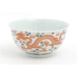 A Chinese famille rose bowl decorated with two dragons and a flaming pearl. Character marks under.