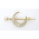A yellow gold brooch set with pearl to one end and with crescent moon to centre set with 15