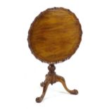 A 20thC tripod table with a pie crust top and a revolving, tilt top birdcage mechanism,, having a