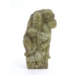 A Chinese carved soapstone figure depicting the Chinese God of Longevity, Shou Lao holding the peach