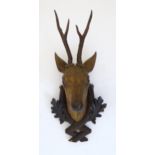 A 19thC Continental Black Forest carved wooden Roe Buck head. Approx. 24 1/2" high Please Note -