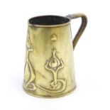 An Art Nouveau brass jug / tankard with stylised floral motifs by Joseph Sankey and Sons. Marked