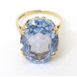 A 9ct gold ring set with large oval cut aquamarine. The stone approx. 3/4" long. Ring size approx.