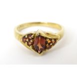 A 9ct gold ring set with garnets. Ring size approx N Please Note - we do not make reference to the