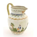 A late 18th / early 19thC jug decorated in Prattware colours depicting a landscape scene with a