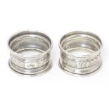 A pair of silver napkin rings with engraved decoration, hallmarked Chester 1912, maker S.