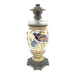 A Victorian Arts & Crafts oil lamp, the ceramic Zsolnay body of vase form decorated with birds,