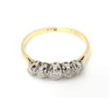 An 18ct gold ring set with five diamonds. Ring size approx. R Please Note - we do not make reference