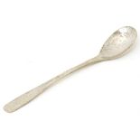 An Arts & Crafts style silver spoon with hammered decoration, hallmarked Sheffield 1959, maker