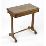 A Victorian oak card table with a moulded, revolving and folding top above two straight supports