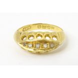 An 18ct gold ring set with diamonds and white stones in a linear setting. Ring size approx. H Please