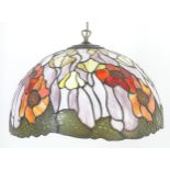 A Tiffany style pendant lampshade with Art Nouveau style floral decoration. Approx. 18" diameter x