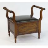 An early / mid 19thC mahogany piano stool / window seat with a lifting leather upholstered seat