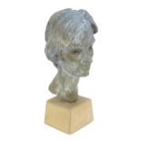 A clay sculpted bust of a woman with a patinated bronze style finish, on a stoneware plinth, by