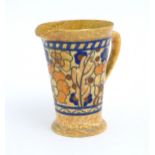 A Charlotte Rhead jug with banded decoration depicting flowers and foliage, designed for Crown