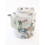 A large Oriental teapot decorated with flowers, foliage and a bird, with scrolling brushwork detail.