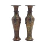 A pair of late 19thC cast patinated bronze vases with flared rims and rope twist detail to neck.