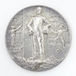 An early 20thC silver plate on bronze fencing medallion / medal designed by Felix Rasumny, depicting