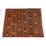 Carpet / Rug : A jajim Kilim, the red ground with banded detail and geometric / chevron motifs.