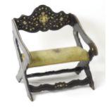 A late 18thC / early 19thC continental x-frame chair, having an ebonised frame with decorative