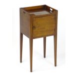 An early 19thC mahogany tray top pot cupboard / bedside cabinet with pierced handles to the top