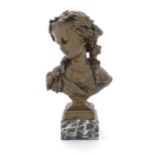 A 20thC cast female bust depicting a Baccante with fruiting vines in her hair and animal stole to