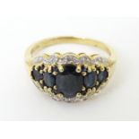 A 9ct gold ring set with sapphires and diamonds. Ring size approx S Please Note - we do not make