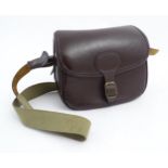 Shooting : a large cartridge bag, constructed from leather with lined interior and canvas strap,