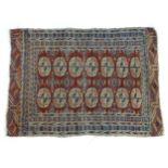 Carpet / Rug: A red ground rug decorated with repeating beige and blue medallions bordered by