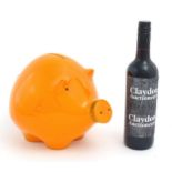 A mid century Italian studio pottery piggy bank modelled as a pig with an orange glaze. Marked