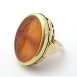 A 9ct gold signet ring set with large carved carnelian seal to centre depicting the
