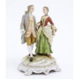 A Karl Ens figural group depicting a gentleman and a lady on a shaped base. Marked under. Approx.