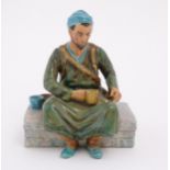 A studio pottery figure modelled as an Egyptian Water Carrier, by Reg Johnson. Signed and titled