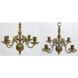 A pair of Dutch brass pendant chandeliers, the candle sconces supported on four scrolling