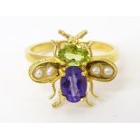 A silver gilt ring with bug / insect detail set with amethyst, peridot and seed pearl. Ring size