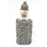 A glass scent / perfume bottle with embossed silver overlay detail, hallmarked Birmingham 1901 maker