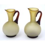 A pair of mid century retro brown and cream glass jugs / small ewers. Approx 5 3/4" high (2)